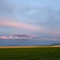Les Trois Buttes,  12x29in Moab Entrada Rag Print ~ In afterglow of solstice the hills of Sweetgrass stretch. Intrusive invaders, an island range Unscathed by Laurentide ice. Weather makers, vision shapers, Sentinels to the spirit world. Kaytosis - Les Trois Buttes.