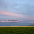 Les Trois Buttes,  12x29in Moab Entrada Rag Print ~ In afterglow of solstice the hills of Sweetgrass stretch. Intrusive invaders, an island range Unscathed by Laurentide ice. Weather makers, vision shapers, Sentinels to the spirit world. Kaytosis - Les Trois Buttes.